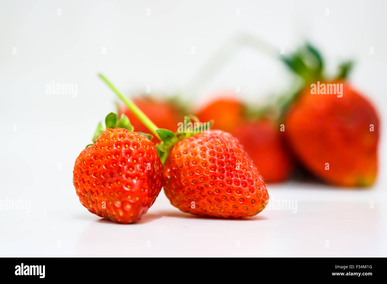 Strawberry berries on a white background Stock Photo - Alamy