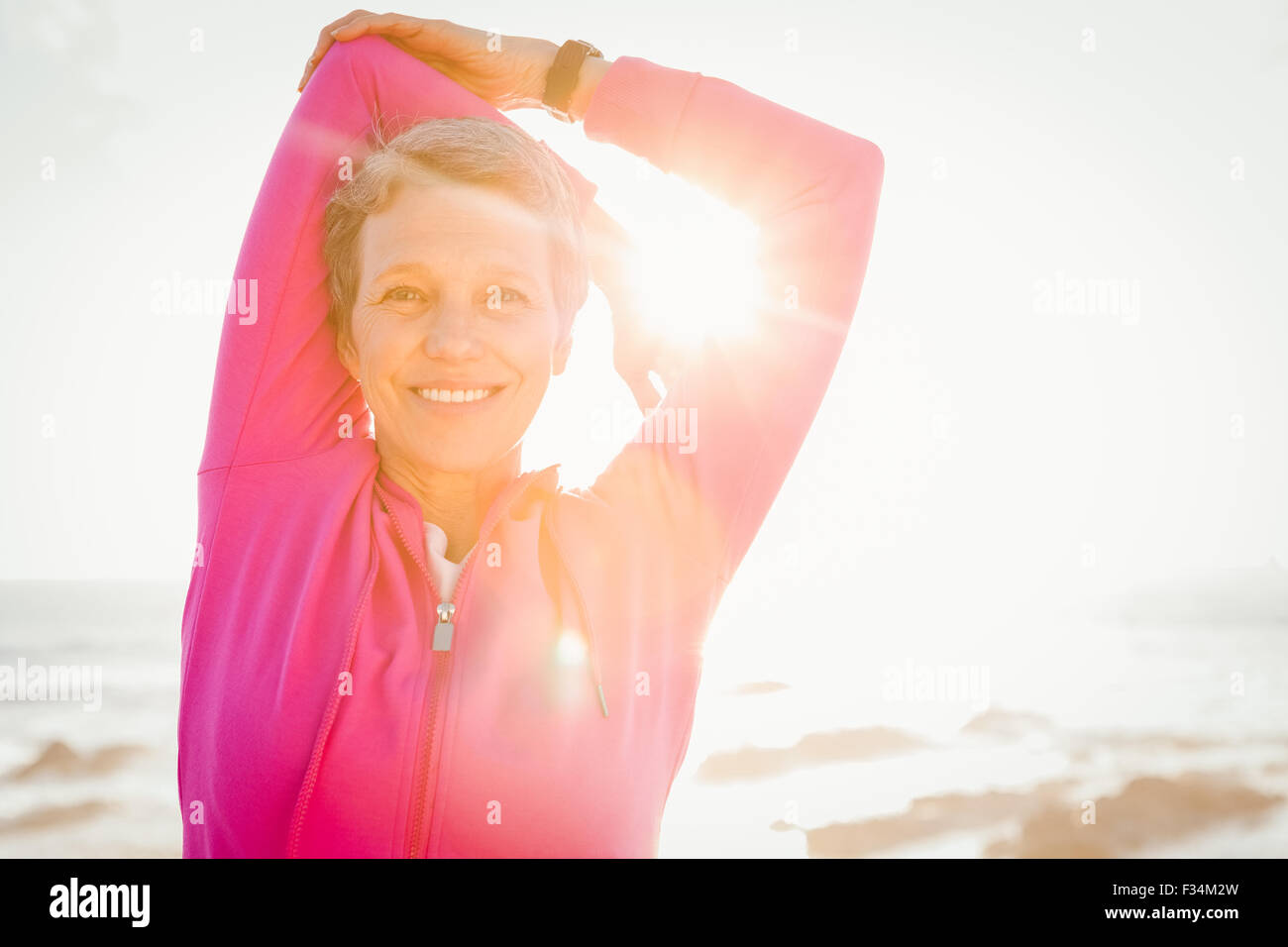 Mature woman arms up smiling hi-res stock photography and images - Alamy