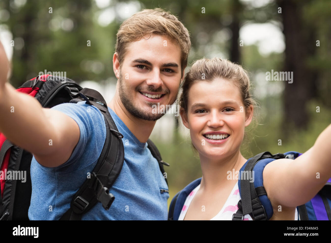 Young happy couple hiking in the nature Stock Photo - Alamy