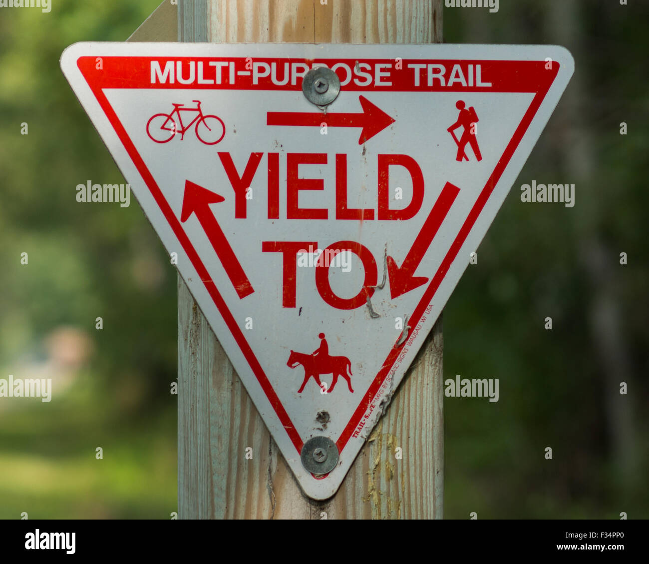 Yield sign at a recreation trail for hiking, biking, horseback riding, and in the winter snowmobiling. Stock Photo