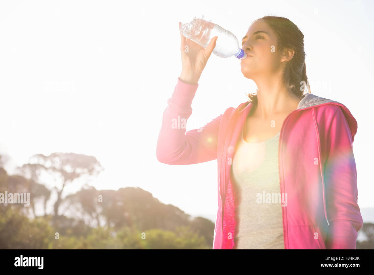 Fit woman drinking water from bottle Stock Photo