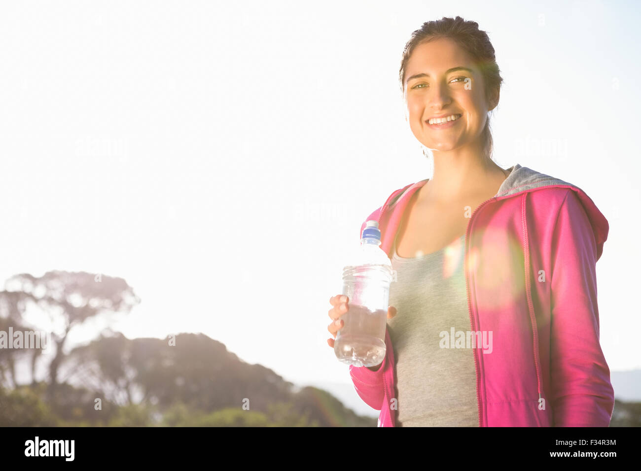 Fit woman drinking water from bottle Stock Photo