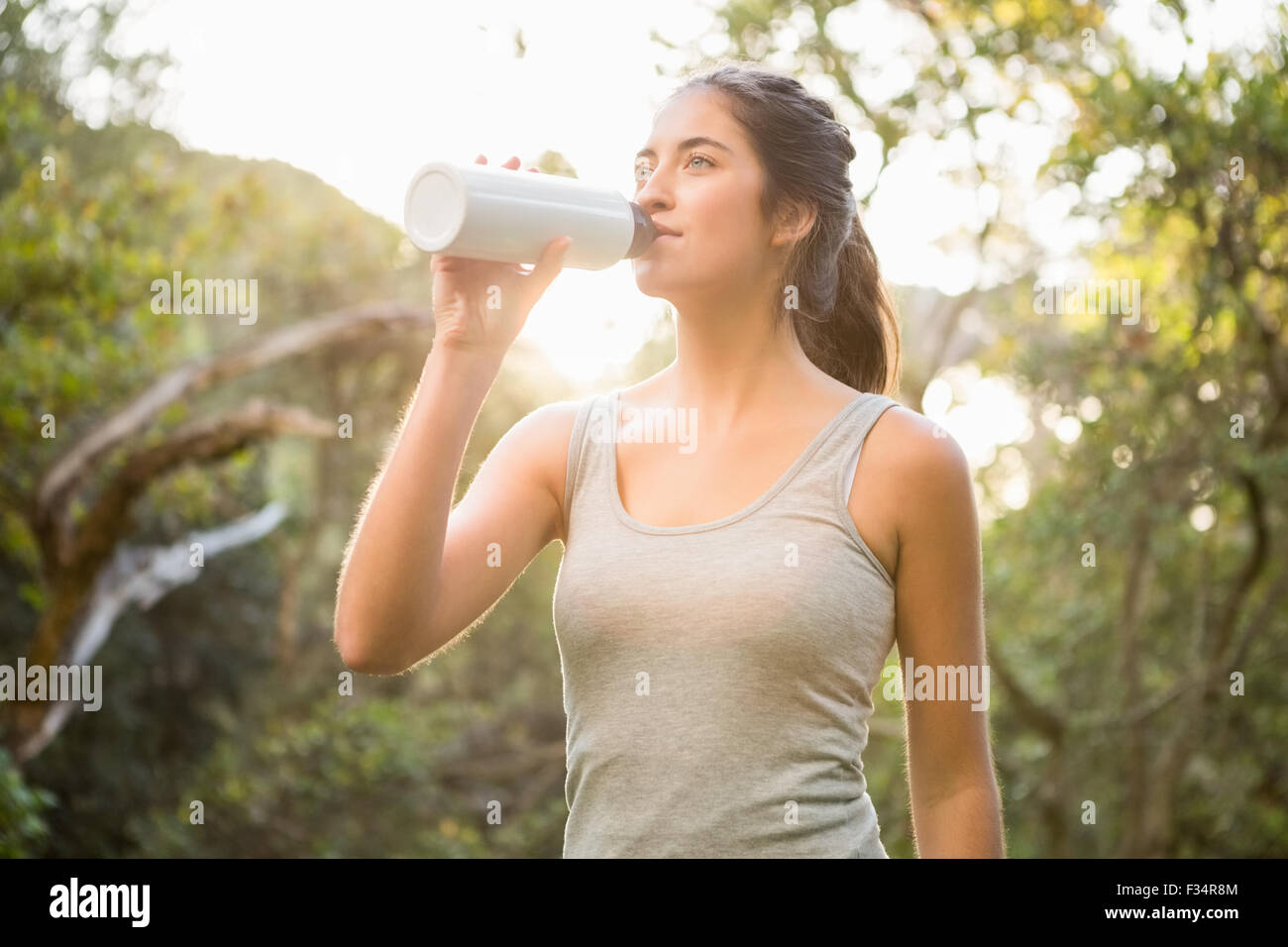 Pretty athletic brunette drinking out of bottle Stock Photo