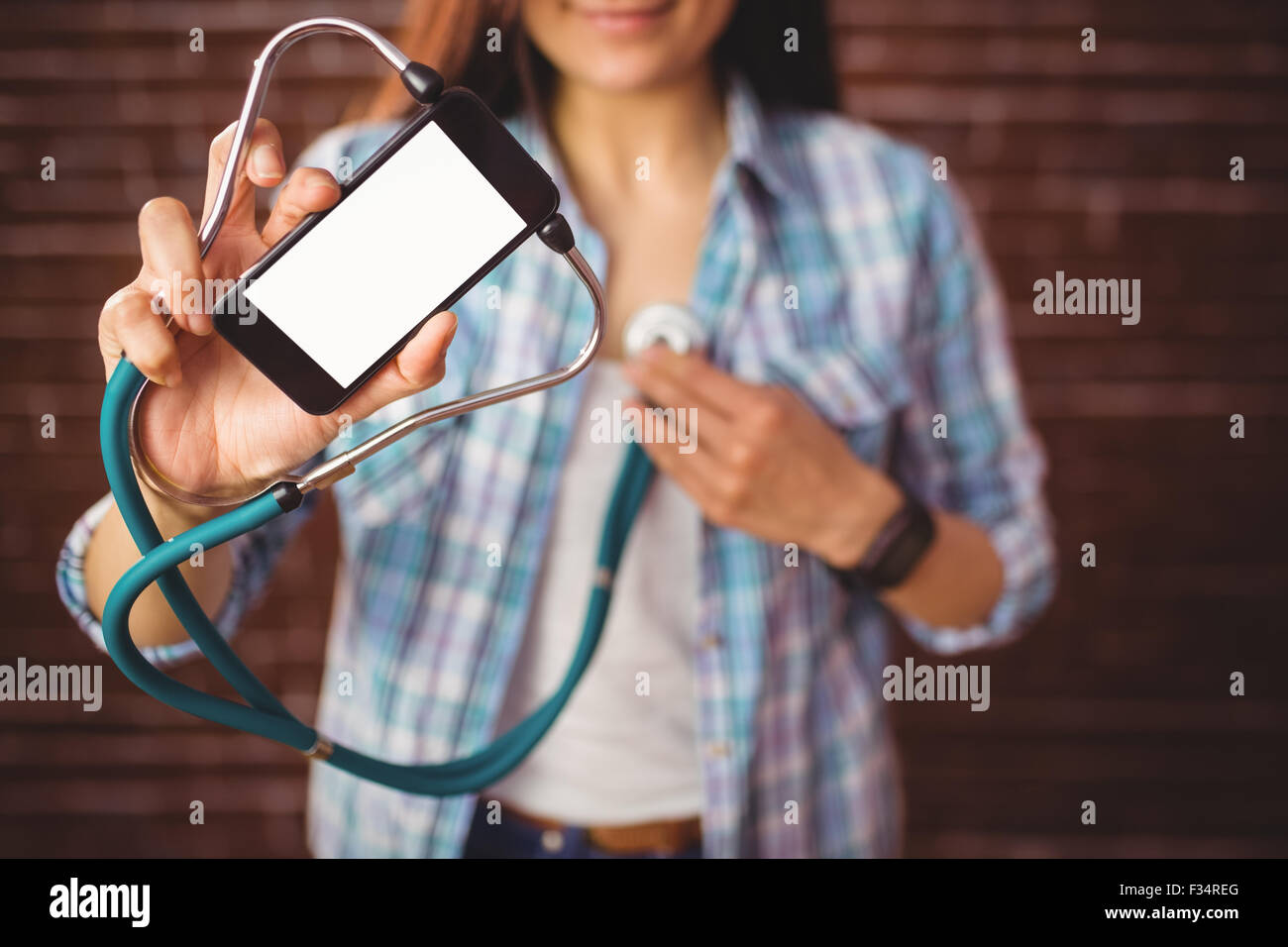 Pretty hipster using her smartphone to diagnose Stock Photo