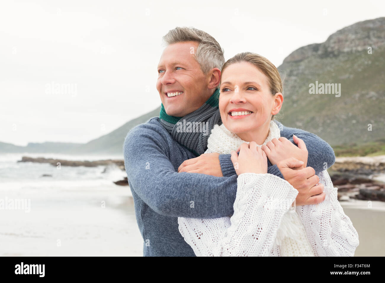 Cute couple standing and holding each other Stock Photo - Alamy