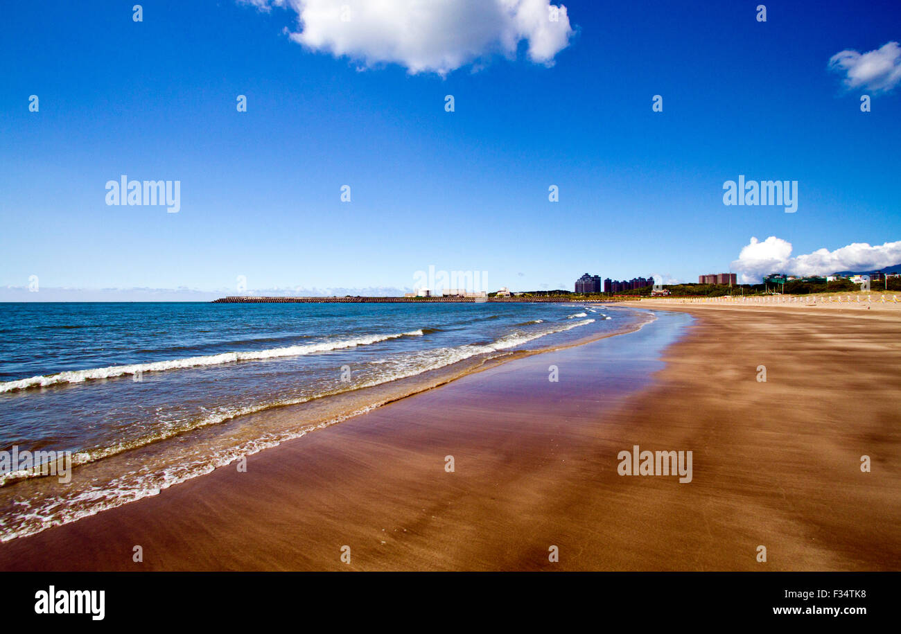 white pebbles by the sea on a cloudy day Stock Photo