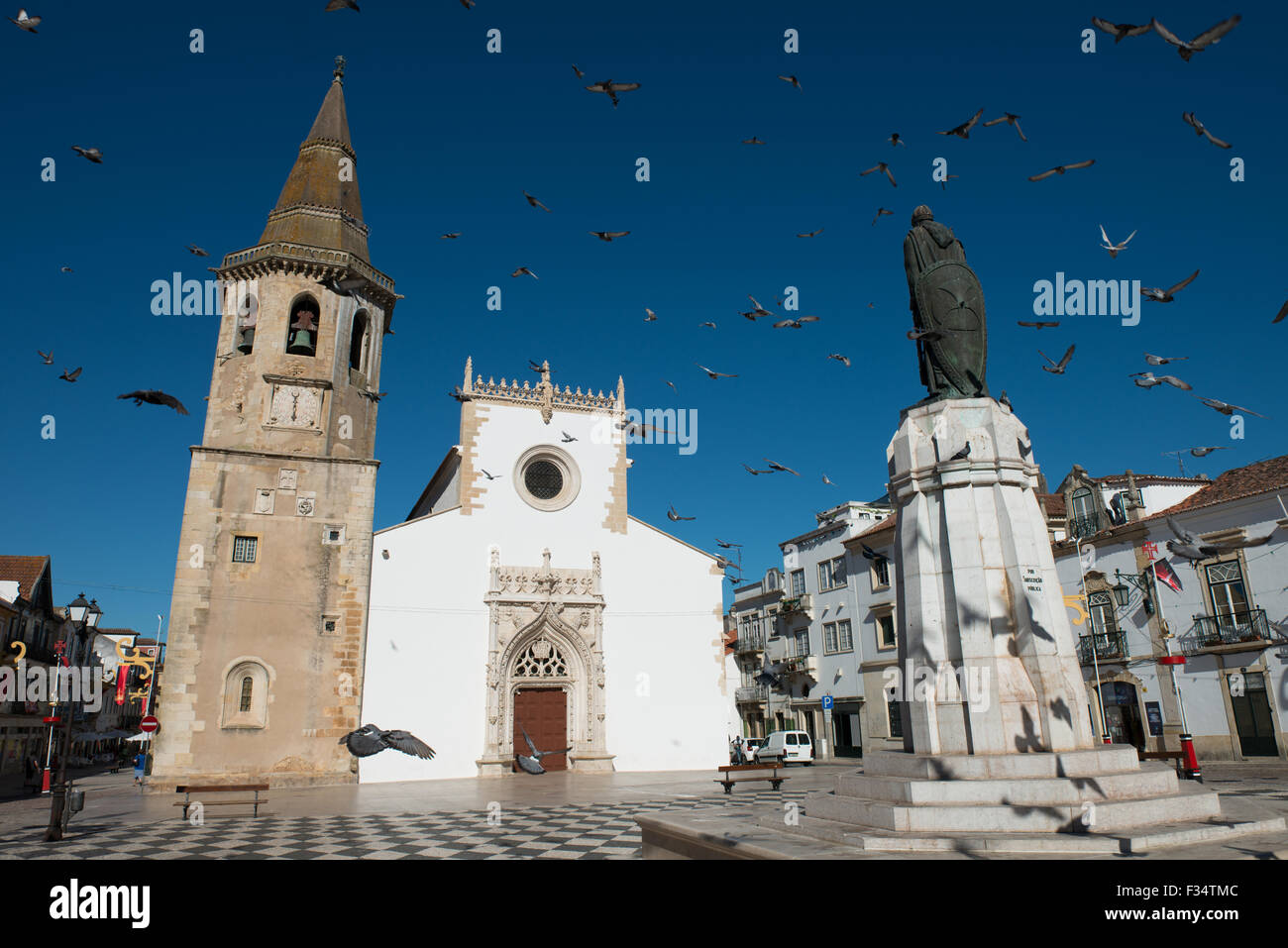 Pigeons fly around the statue of Gualdim Pais in the main square of Tomar. Tomar, Portugal, July 20, 2015. Stock Photo