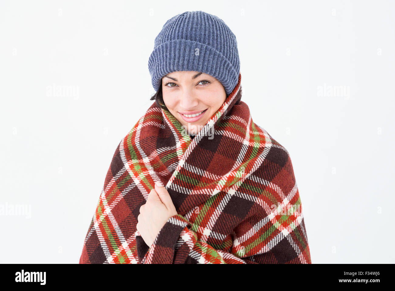 Smiling brunette with checked blanket Stock Photo