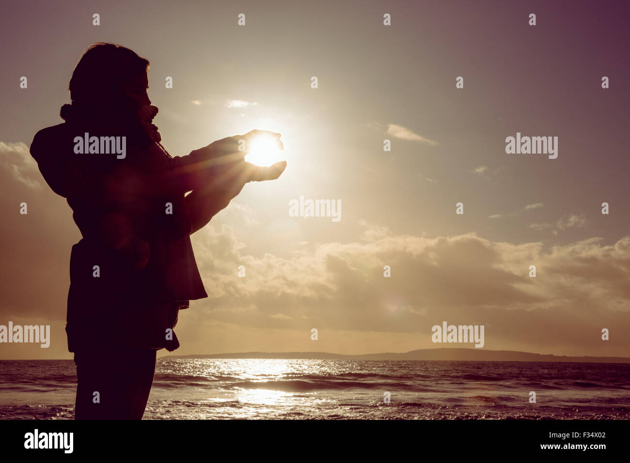 Woman holding the light of the sun Stock Photo - Alamy