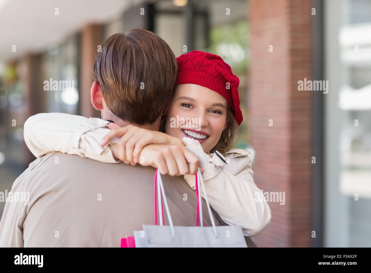 A smiling happy woman hugging her boyfriend Stock Photo - Alamy