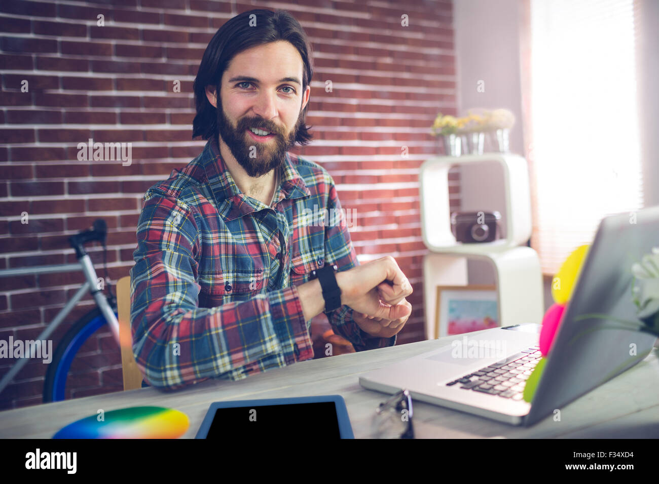 Portrait of smiling businessman checking time Stock Photo - Alamy