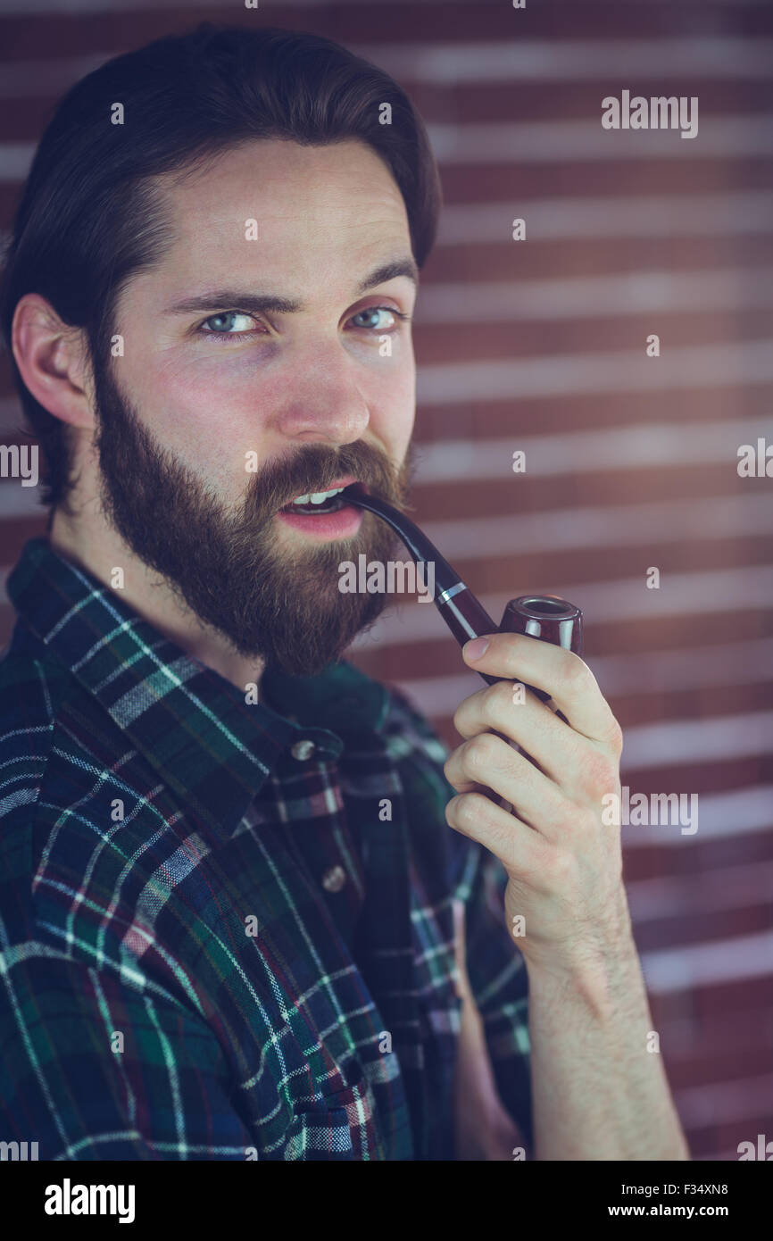Portrait of man smoking pipe Stock Photo