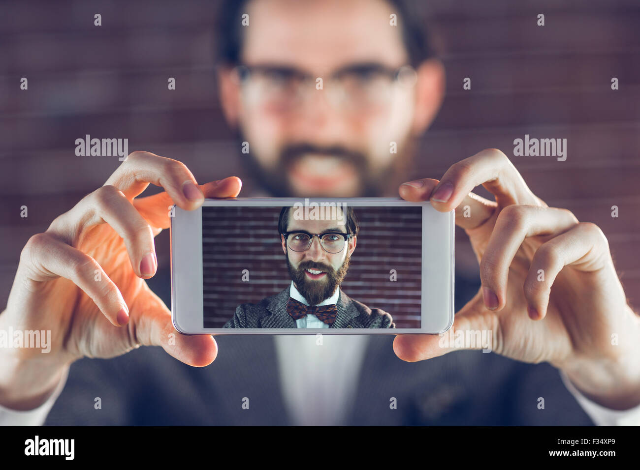 Portrait of man in cellphone taking selfie Stock Photo