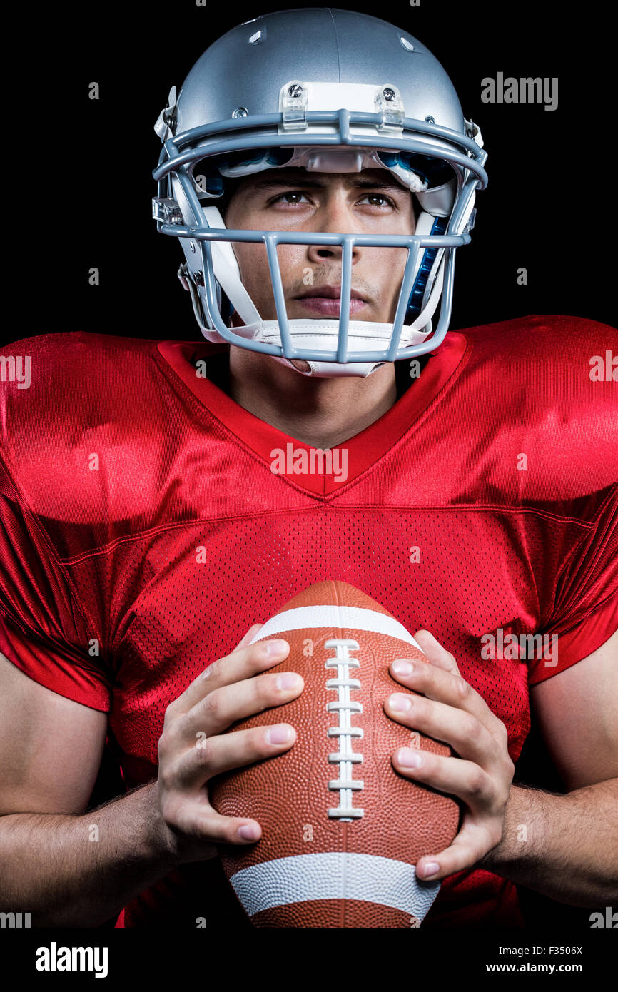 Determined sportsman holding American football Stock Photo - Alamy