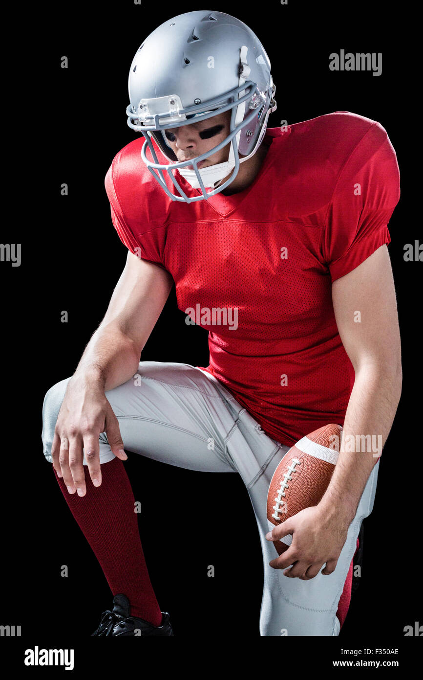 American football player with hand on knee Stock Photo Alamy