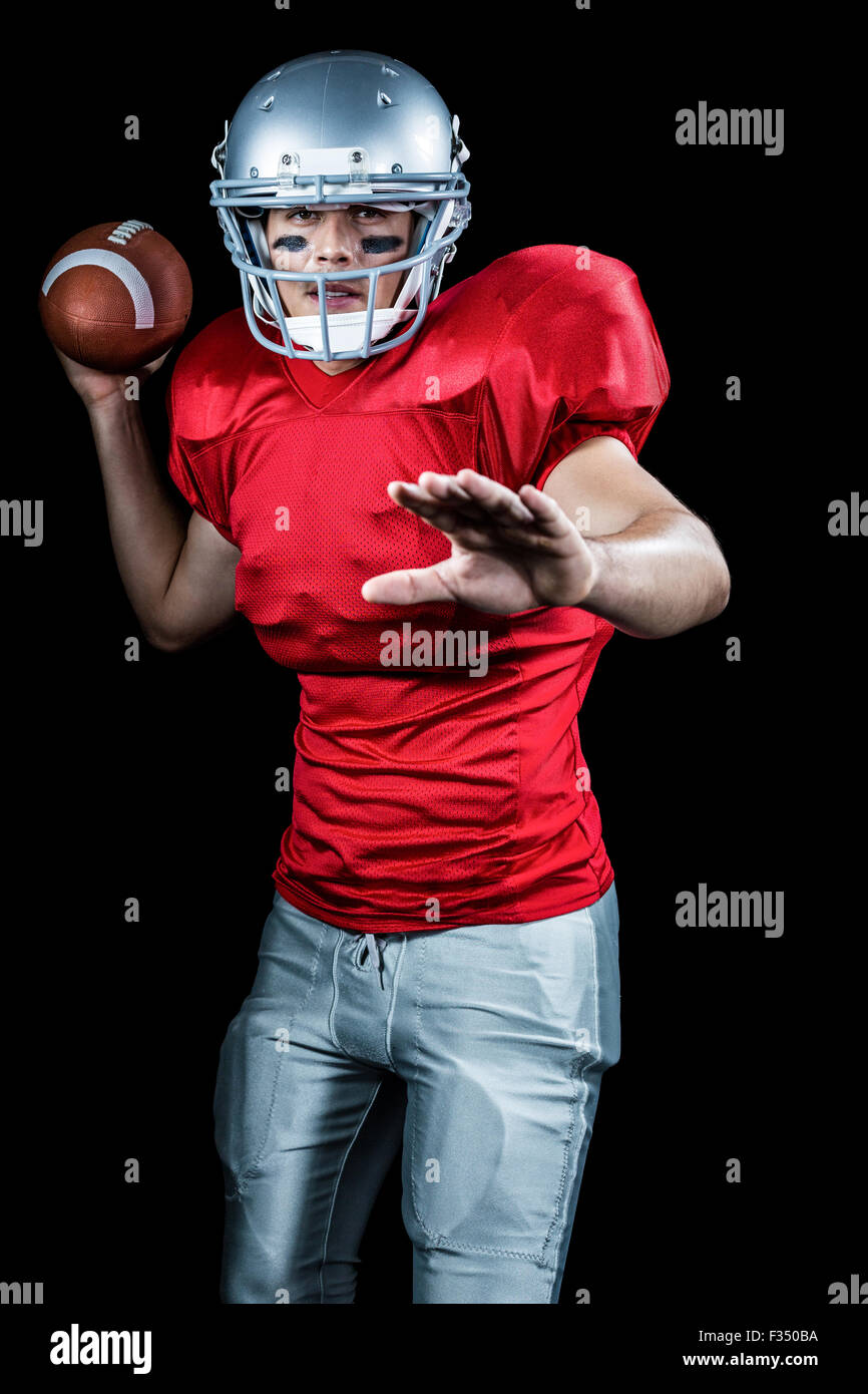 Sportsman throwing American football while playing Stock Photo Alamy