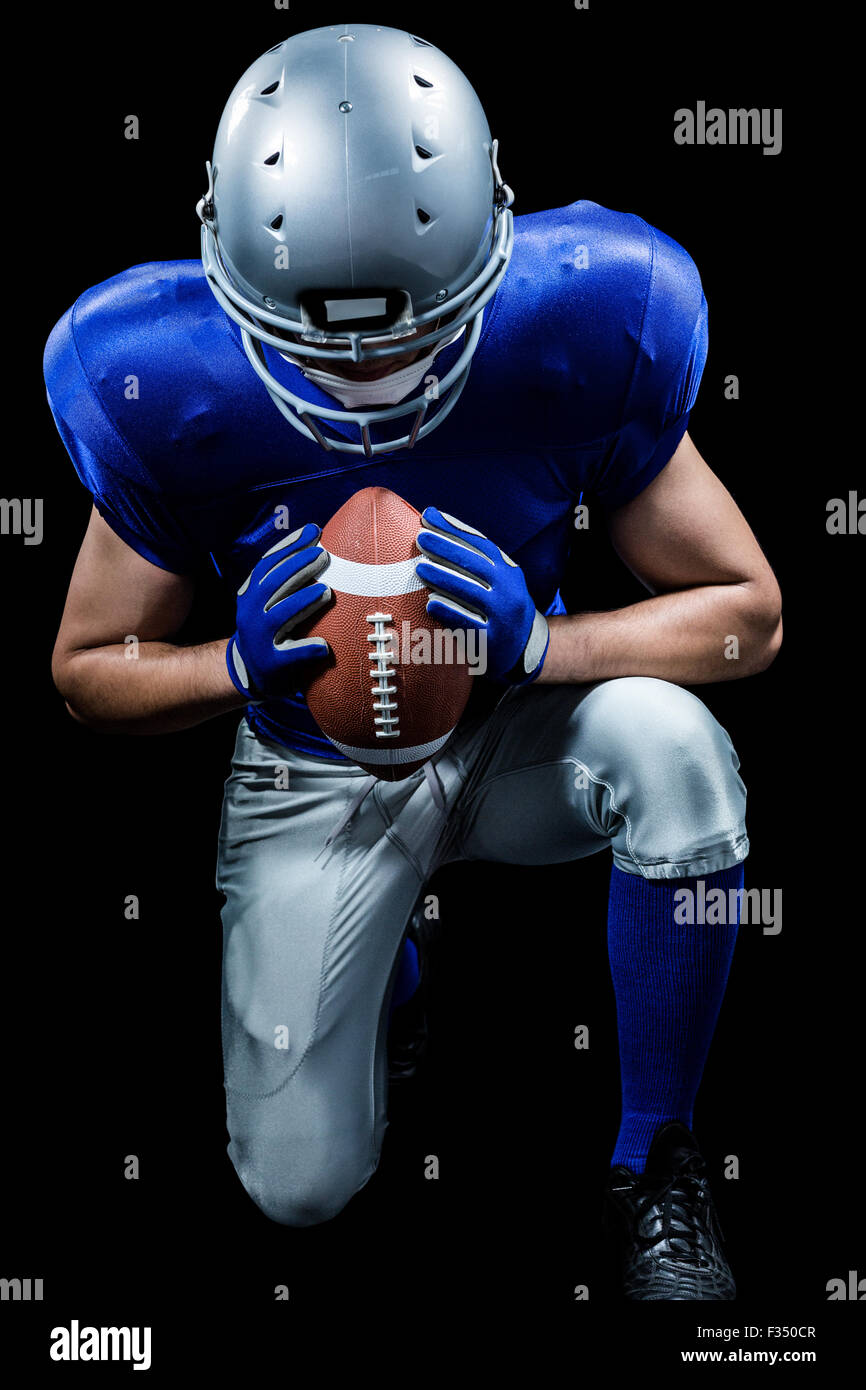 American football player kneeling Stock Photo Alamy