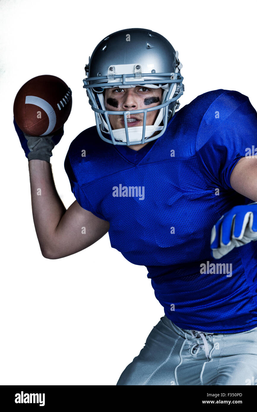 American football player in uniform throwing ball Stock Photo Alamy