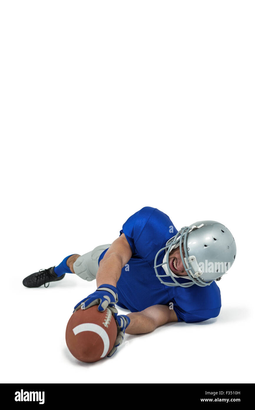 Full length of American football player reaching ball Stock Photo - Alamy