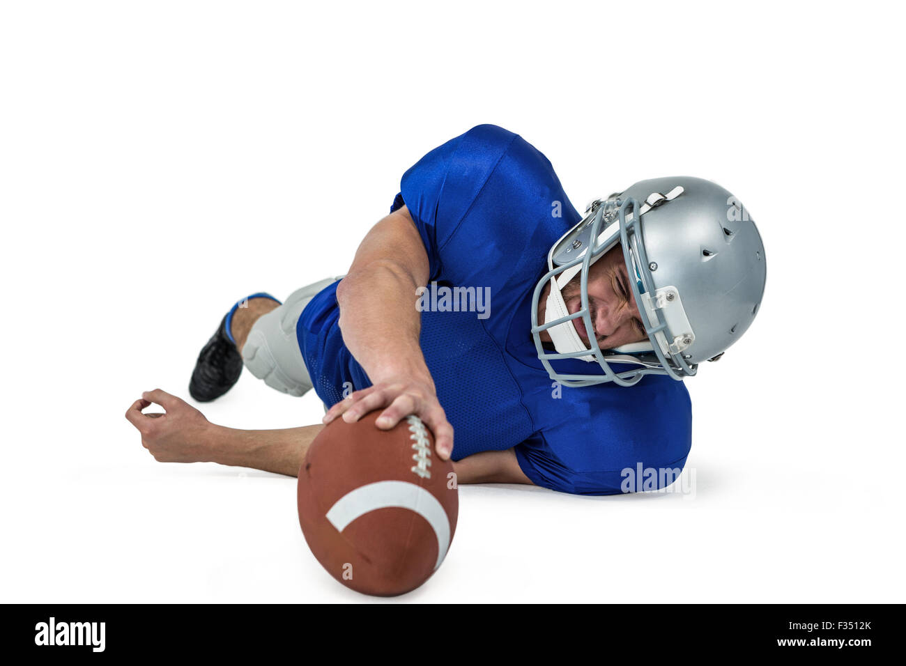 American football player struggling to catch the ball Stock Photo