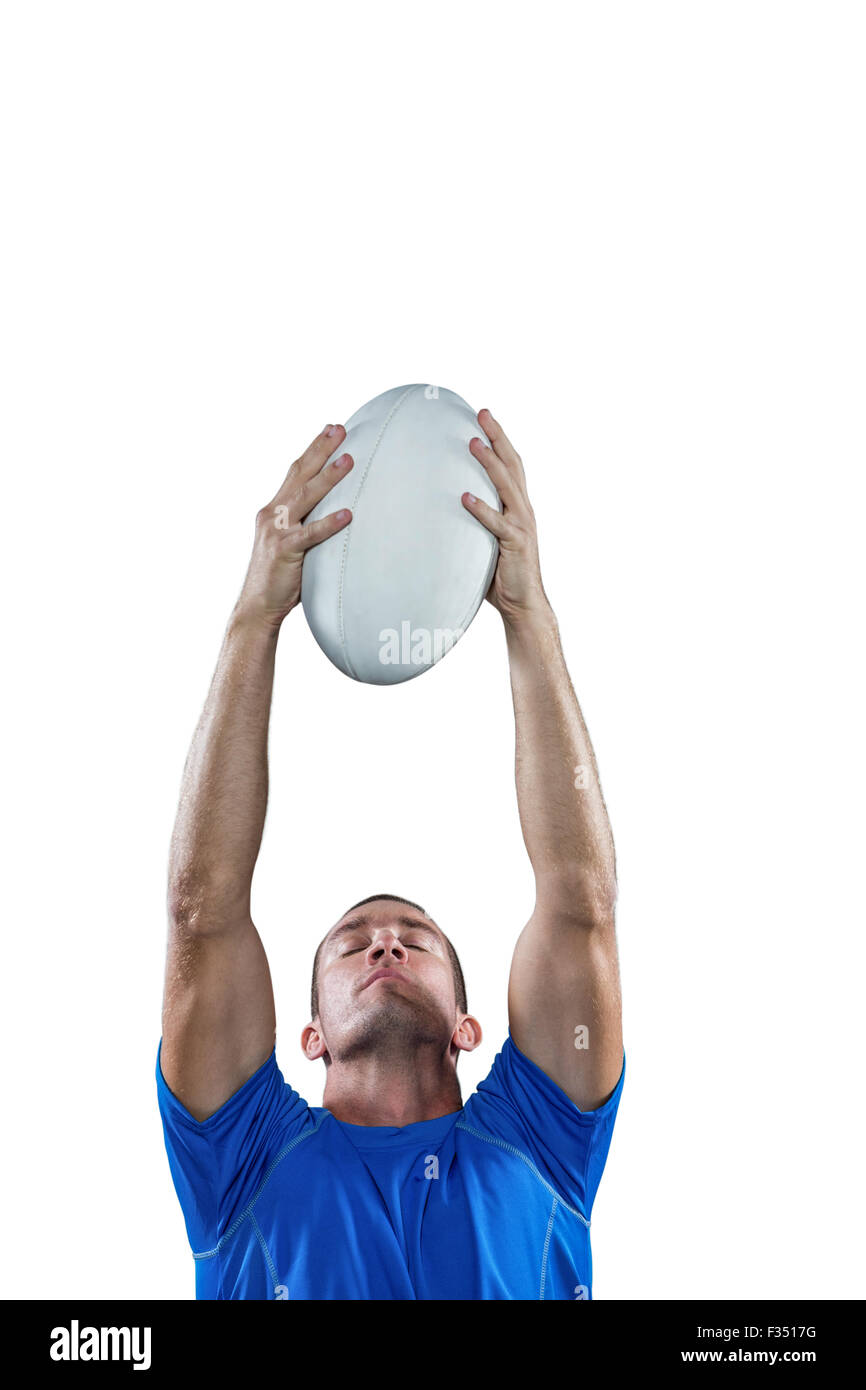 Rugby player holding ball with eyes closed Stock Photo Alamy