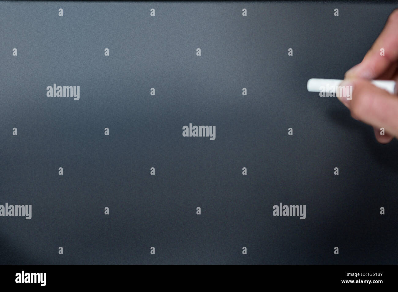 Hand ready to write on blackboard Stock Photo Alamy