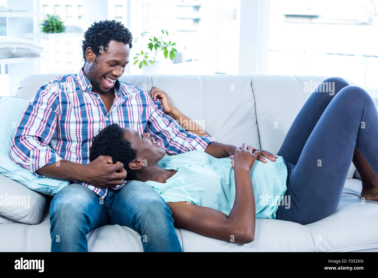 Pregnant wife relaxing on husband lap Stock Photo Alamy