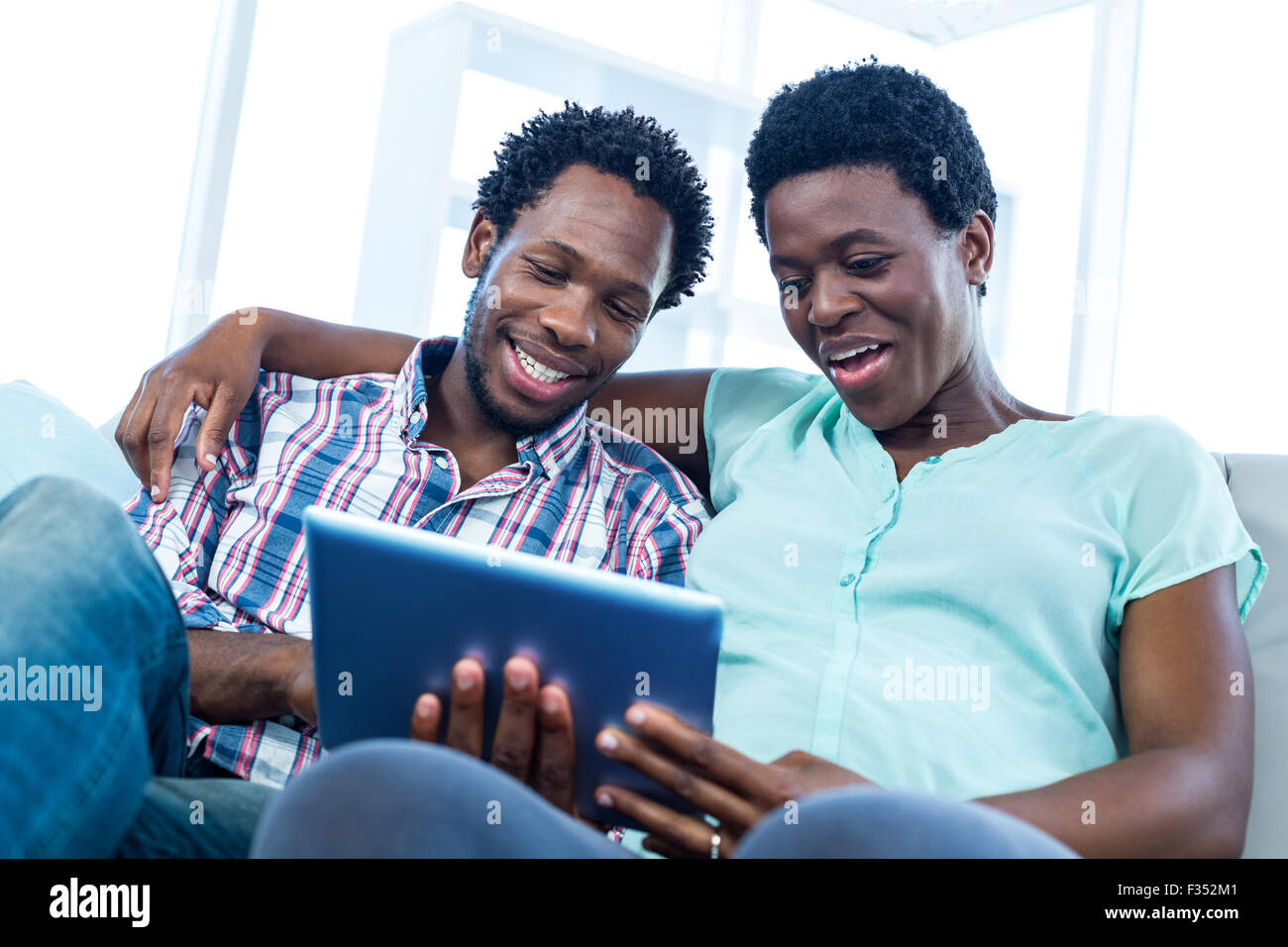 Joyful black couple sitting hi-res stock photography and images - Alamy