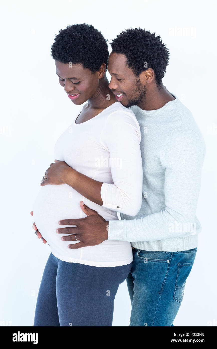 Man hugging his pregnant wife while standing Stock Photo - Alamy