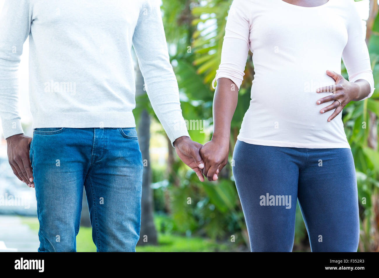 Couple holding hands while walking Stock Photo - Alamy