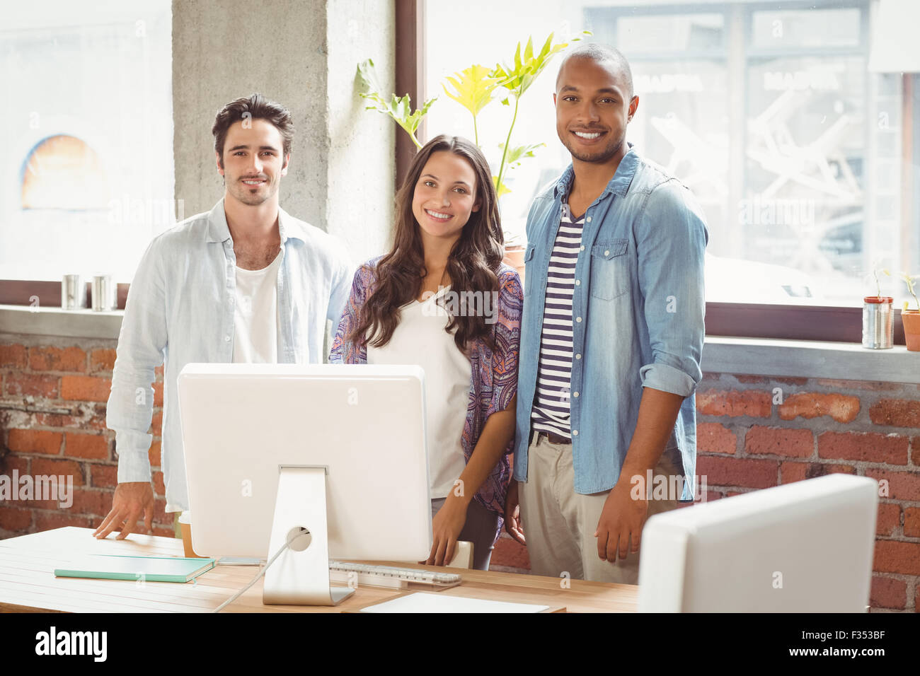 Smiling business people standing in office Stock Photo - Alamy