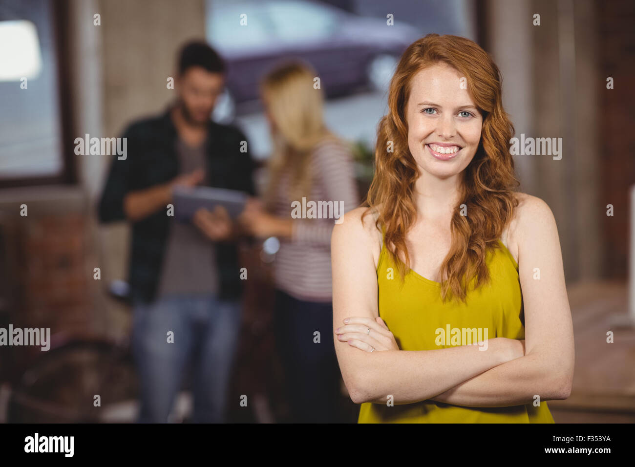 Portrait of smiling beautiful woman with arms crossed Stock Photo - Alamy