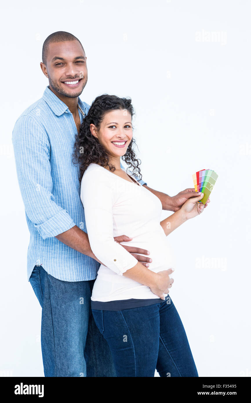 Portrait of smiling husband with wife holding colour samples Stock Photo
