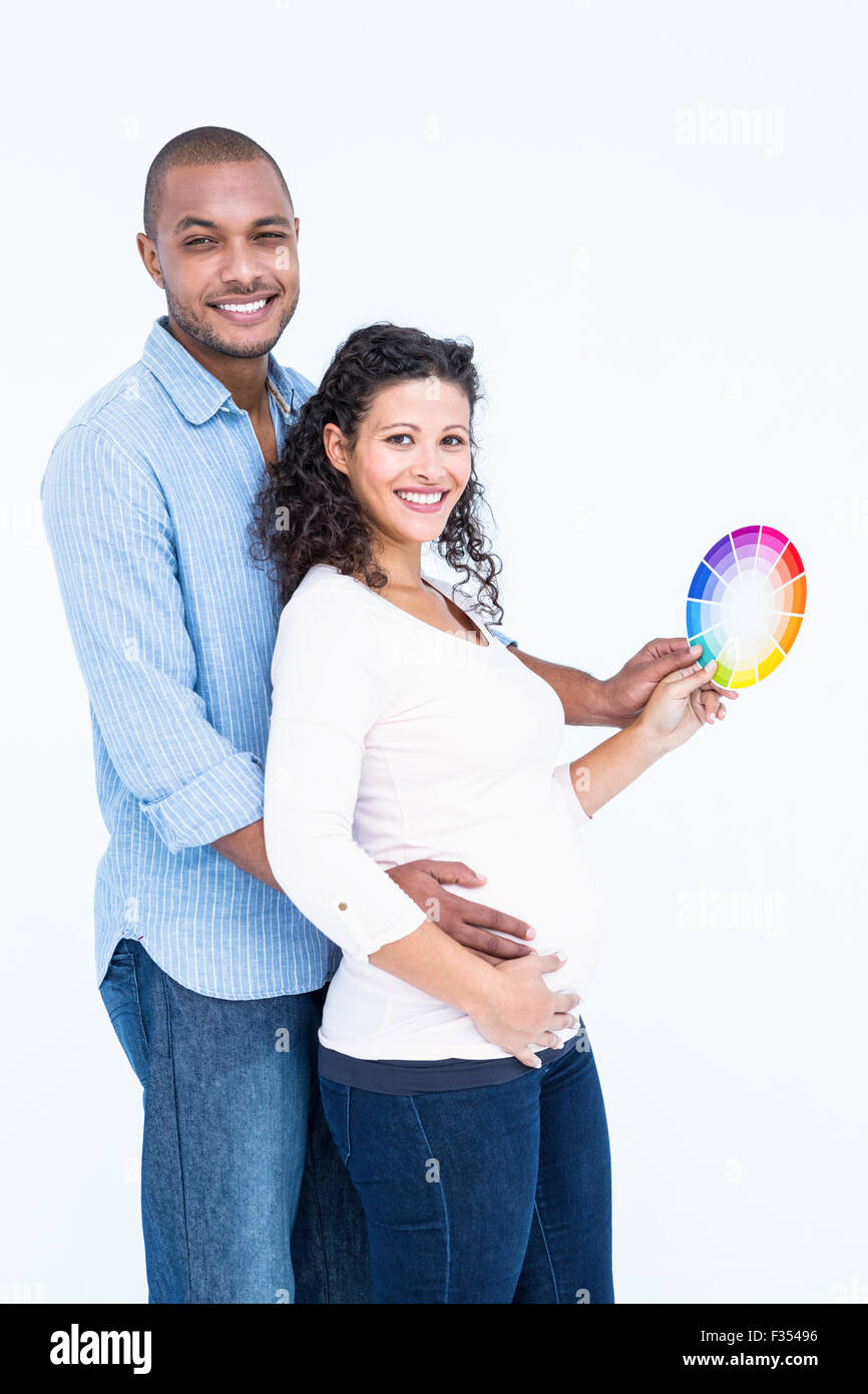 Portrait of smiling husband with wife holding color wheel Stock Photo