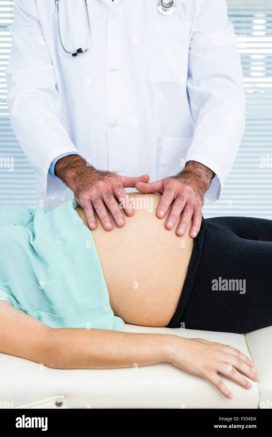 Pregnant woman being checked by doctor Stock Photo