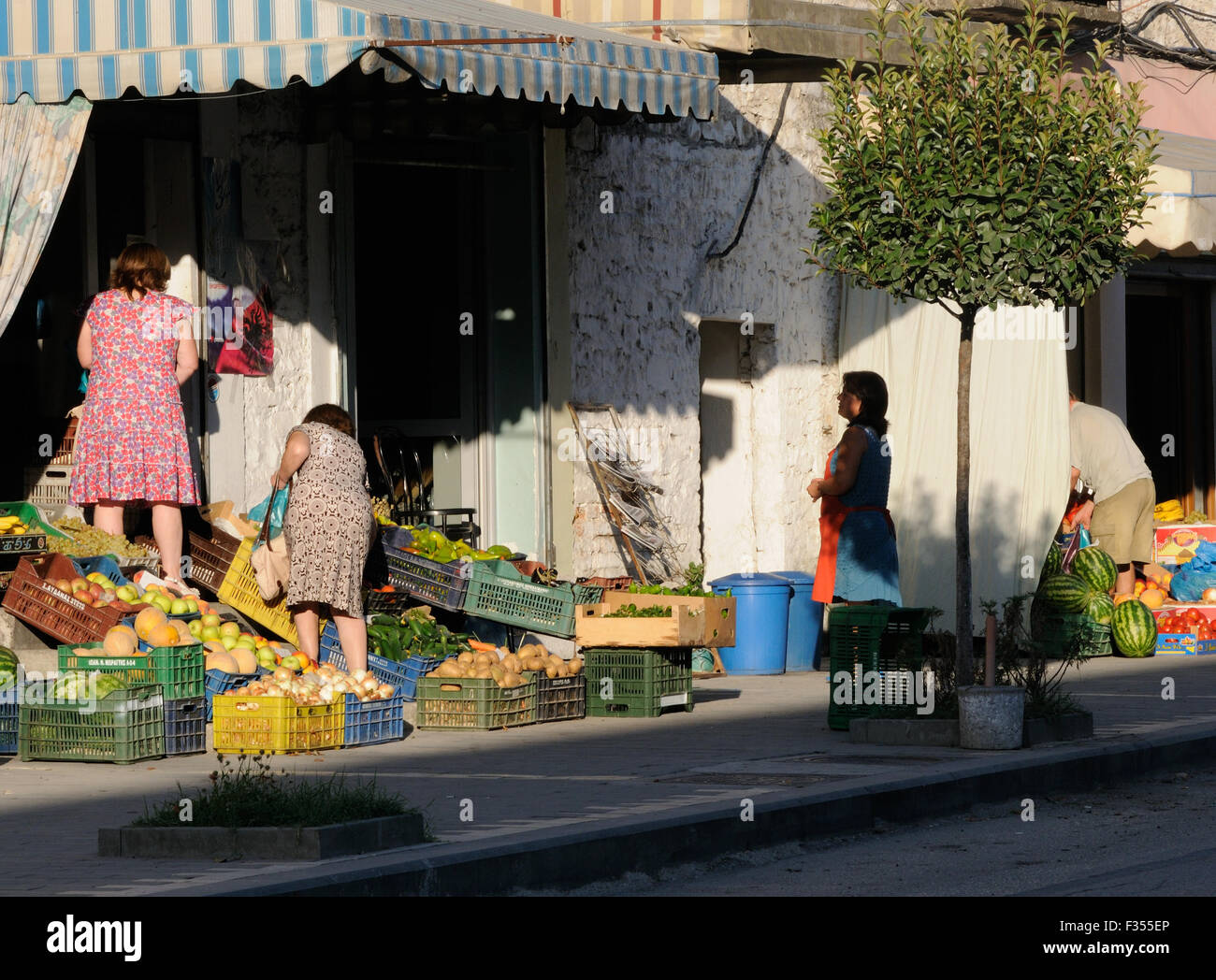 Women shop for vegetables in the  world heritage site of  Mangalemi, The Ottoman quarter of Berat.  Berat, Albania. Stock Photo