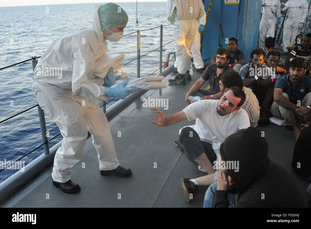 Soldier Sandra K Hands Out Blankets To Refugees Aboard The Frigate soldier-sandra-k-hands-out-blankets-to-refugees-aboard-the-frigate