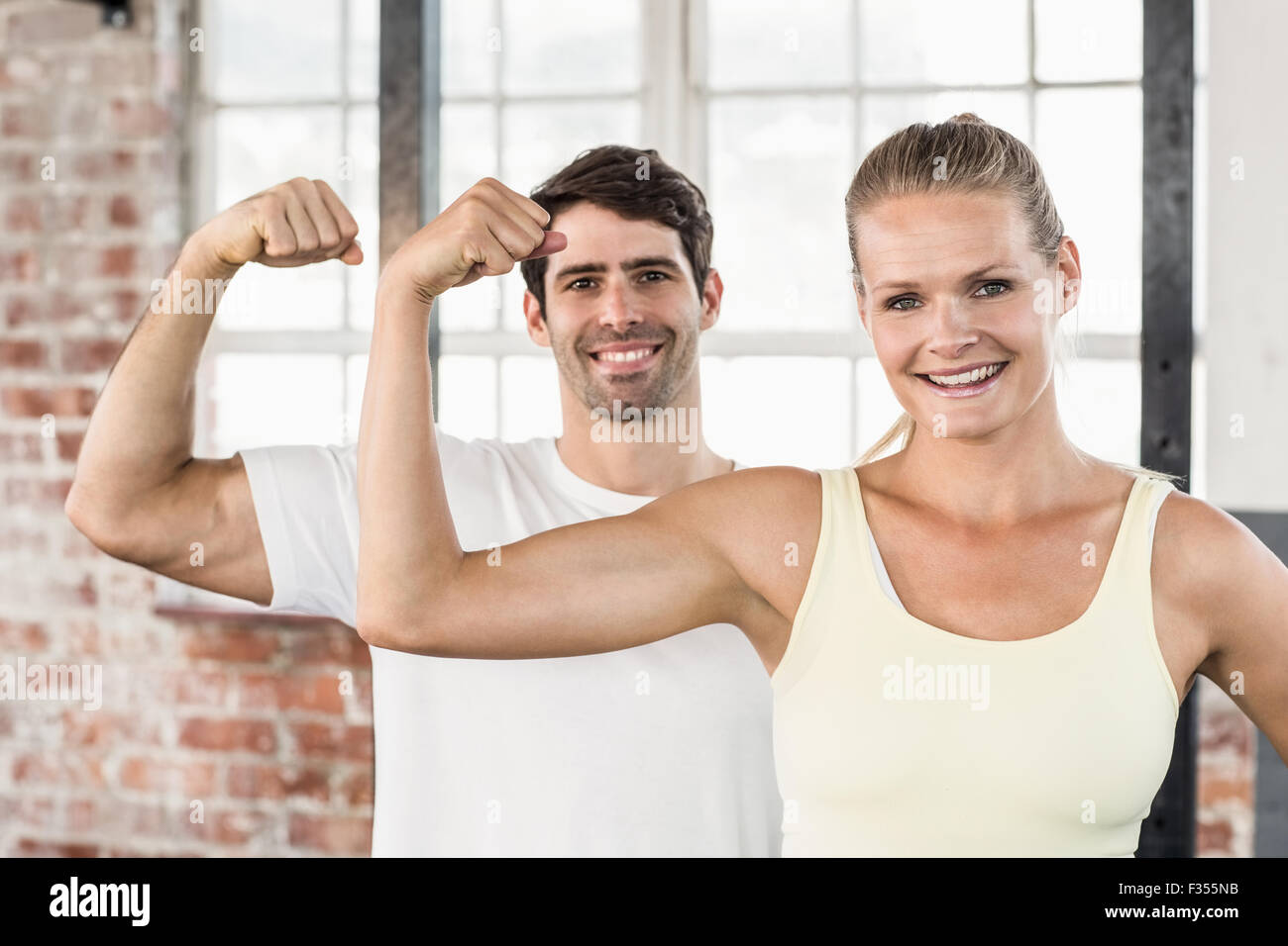 Portrait of couple flexing muscles Stock Photo