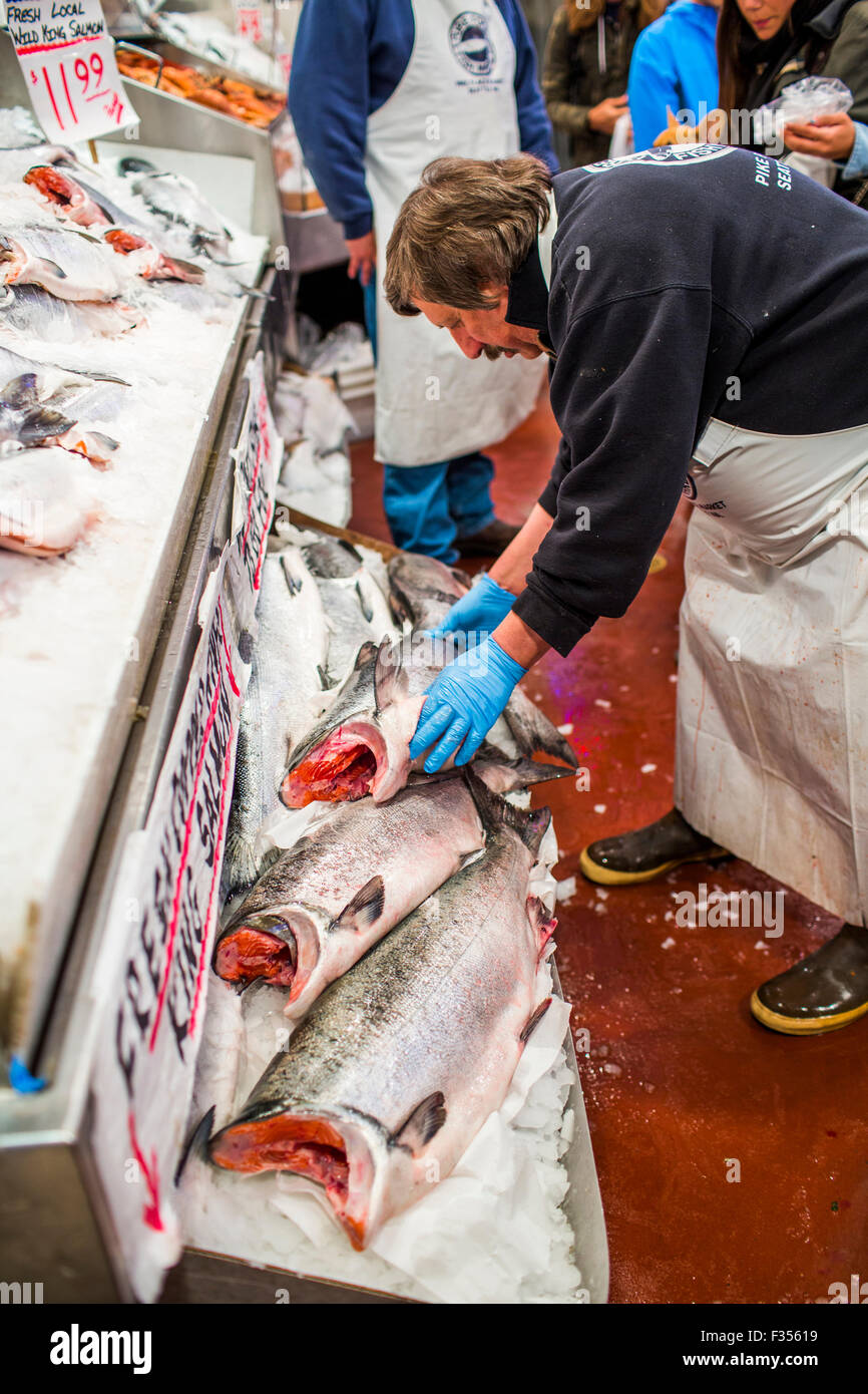 A man organizes large salmon at his stand at Pike Place Market in Seattle,  WA Stock Photo - Alamy