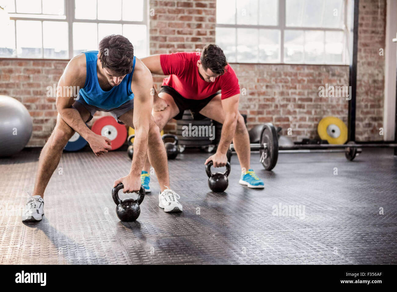 Men doing exercise with kettlebell Stock Photo