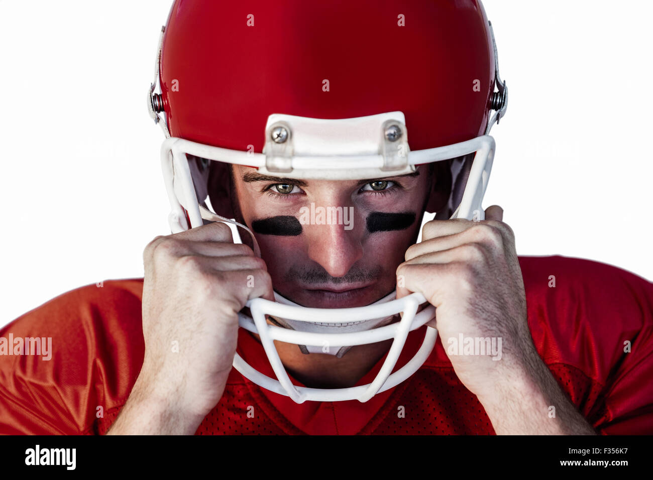 Portrait of rugby player wit hands on helmet Stock Photo