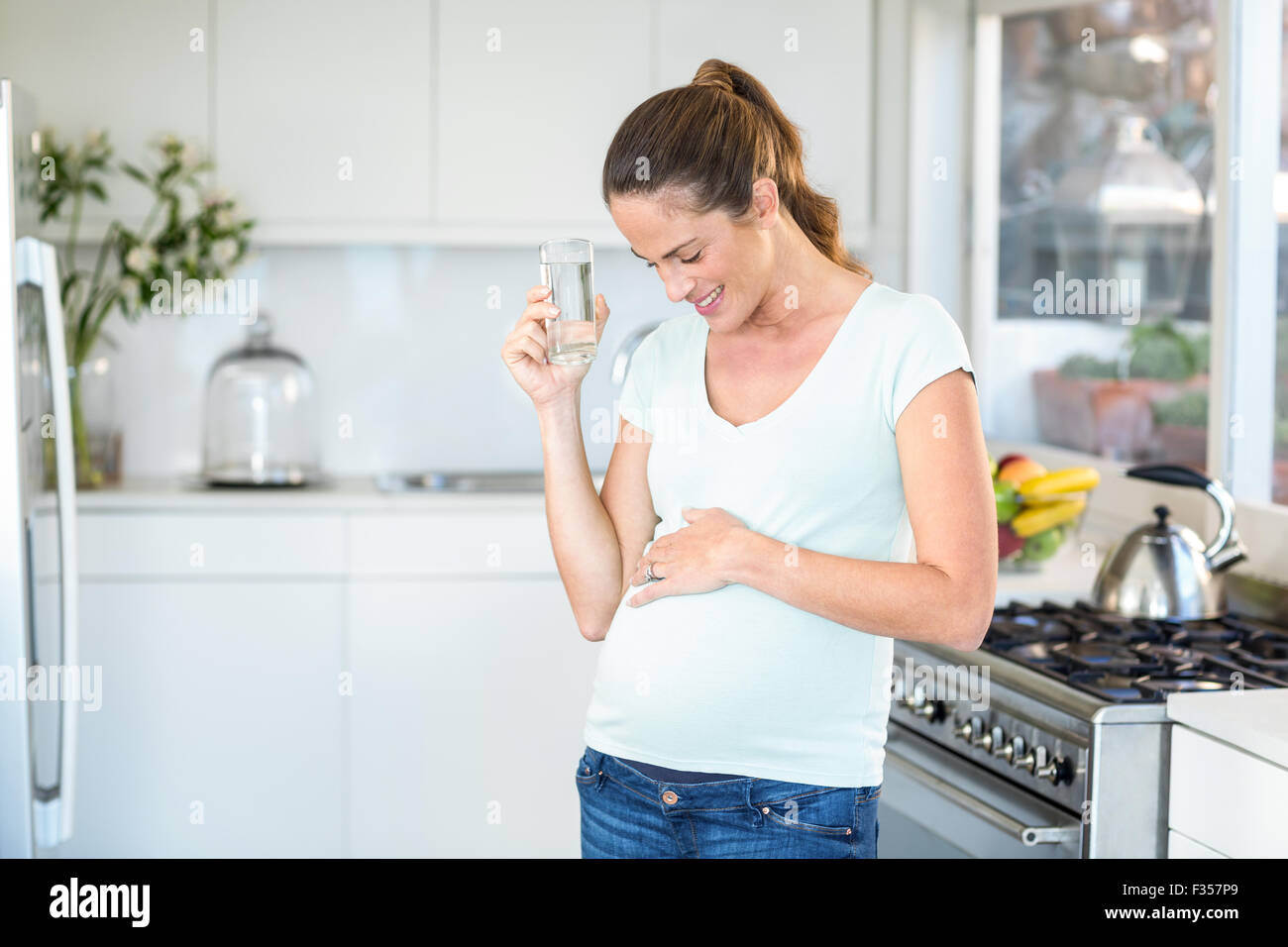 Happy woman standing with water Stock Photo