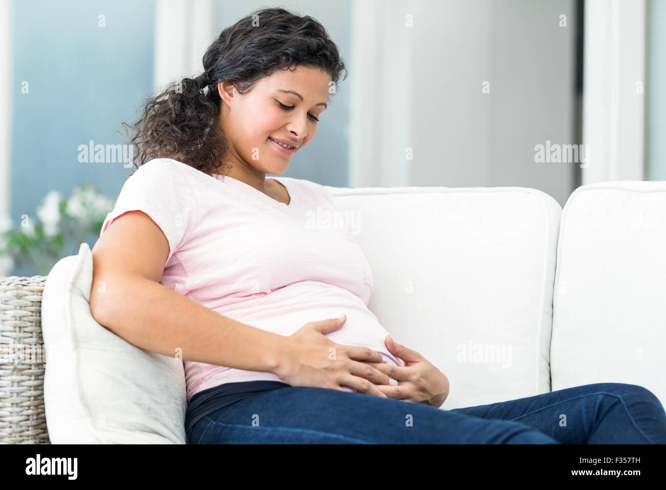 Woman happy home sofa hi-res stock photography and images - Alamy