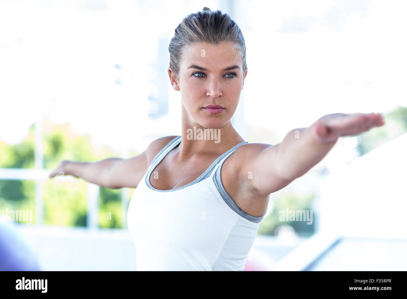 Focused woman with arms outstretched Stock Photo