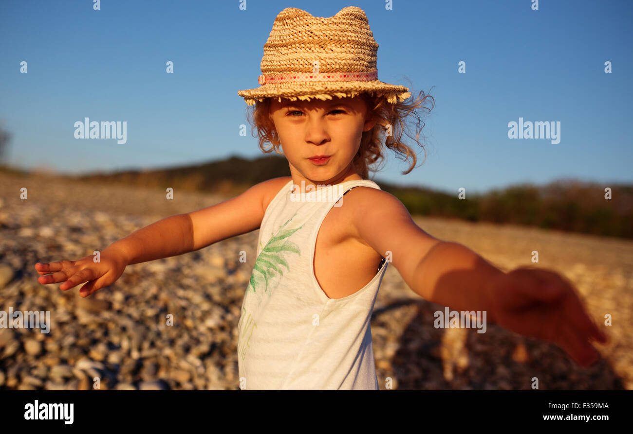 Cute little girl emotional outdoor portrait in warm light of sunset Stock Photo