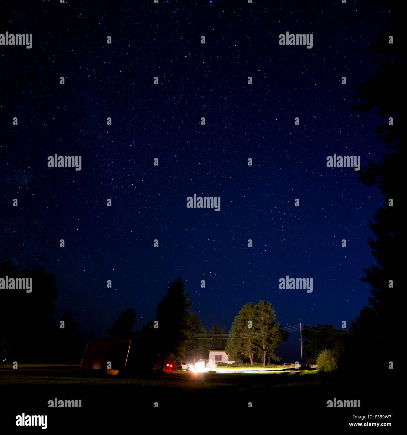 Night starry sky scene and lights of cottages Stock Photo - Alamy