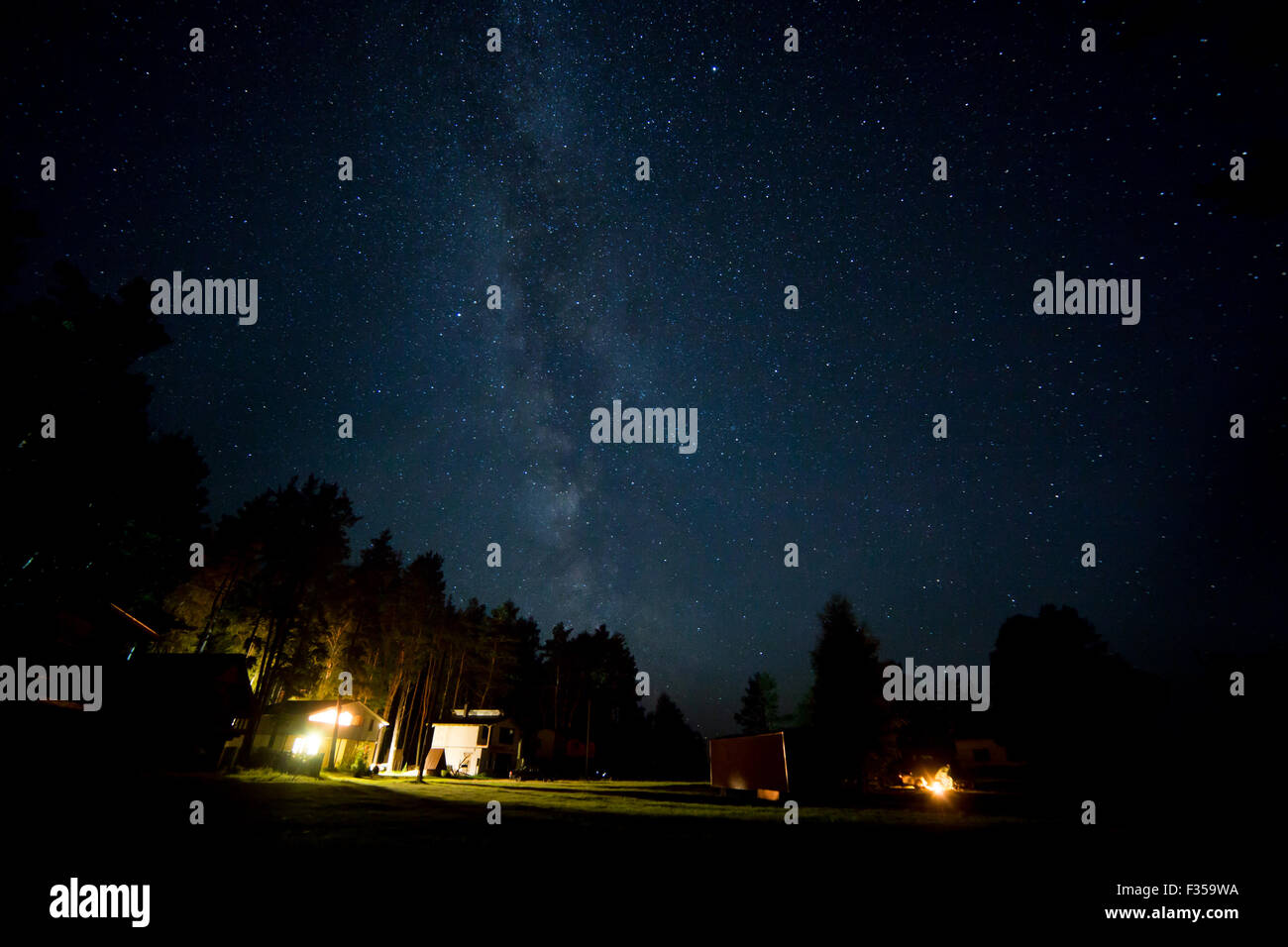 Night starry sky scene with milky way and lights of cottages Stock ...