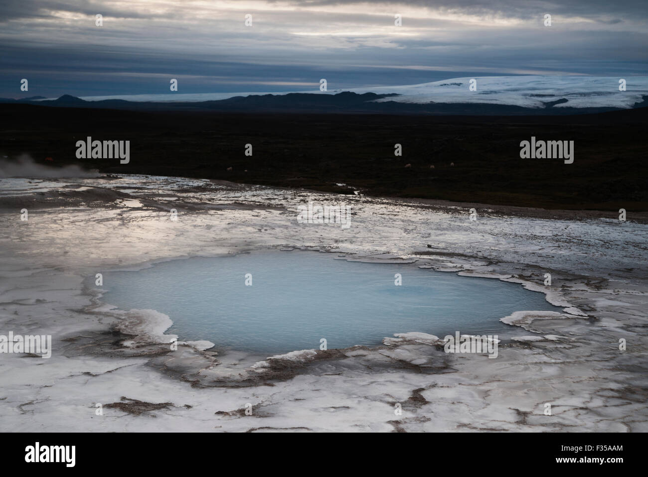 Milky blue mineral water in a pond surrounded by white calcified land in a geyserfield at dawn, Hveravellir, Kjorlur Interior Stock Photo