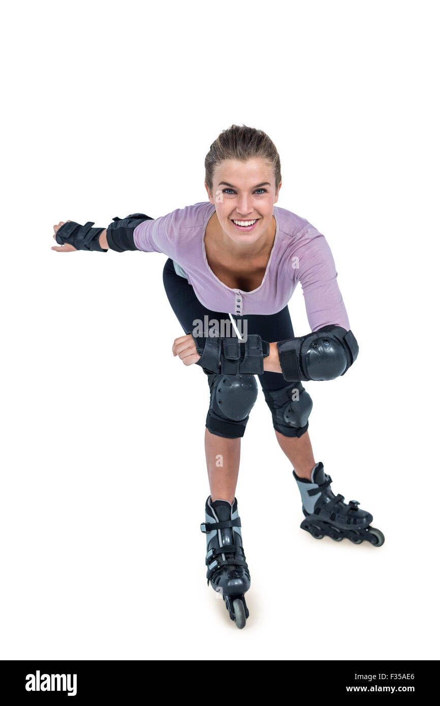 Portrait of happy young woman inline skating Stock Photo