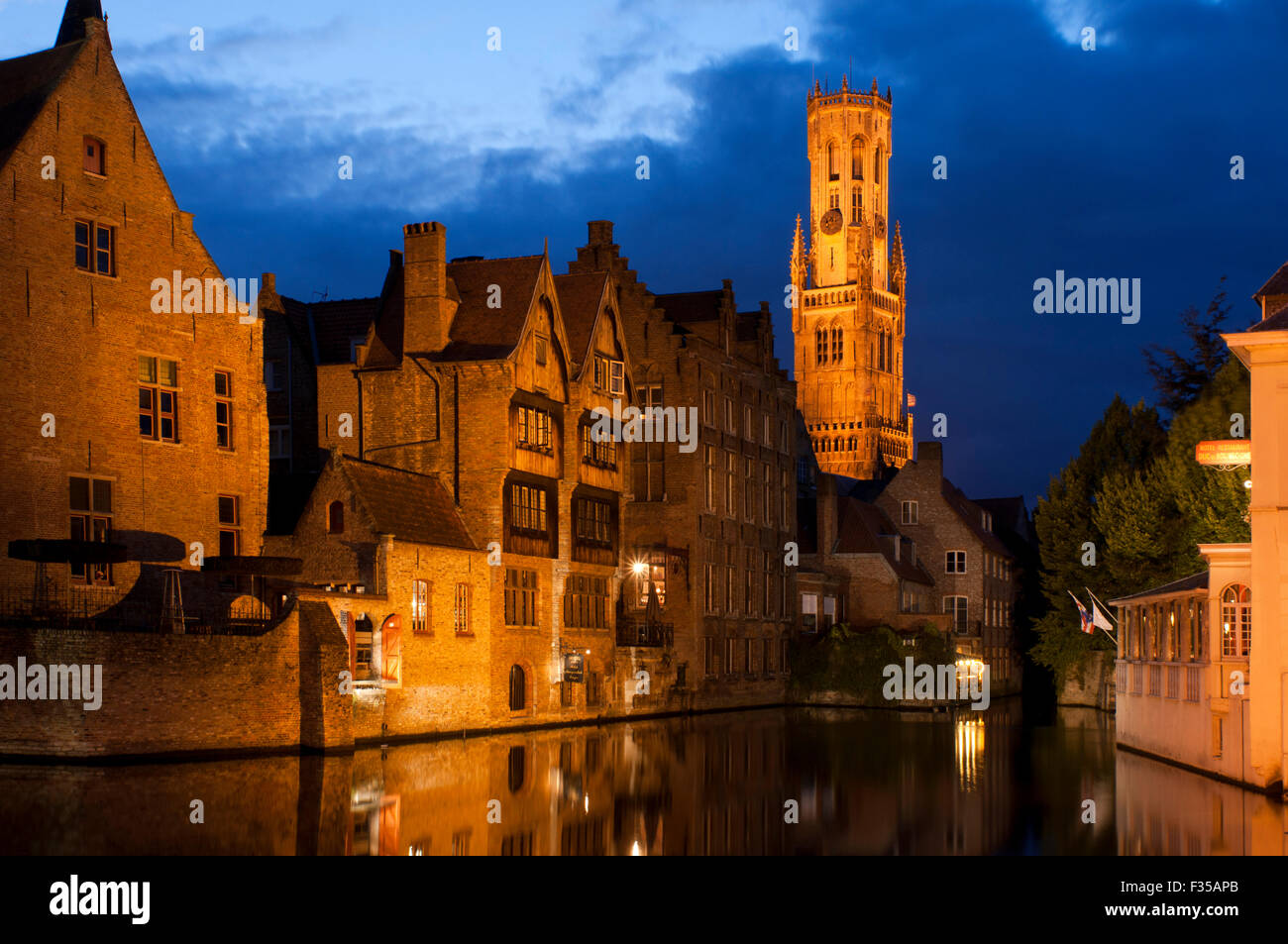 Bruges at night with the Belfry in the background, the most tipical landscape in Bruges. Evening view over Bruges : the Dijver c Stock Photo